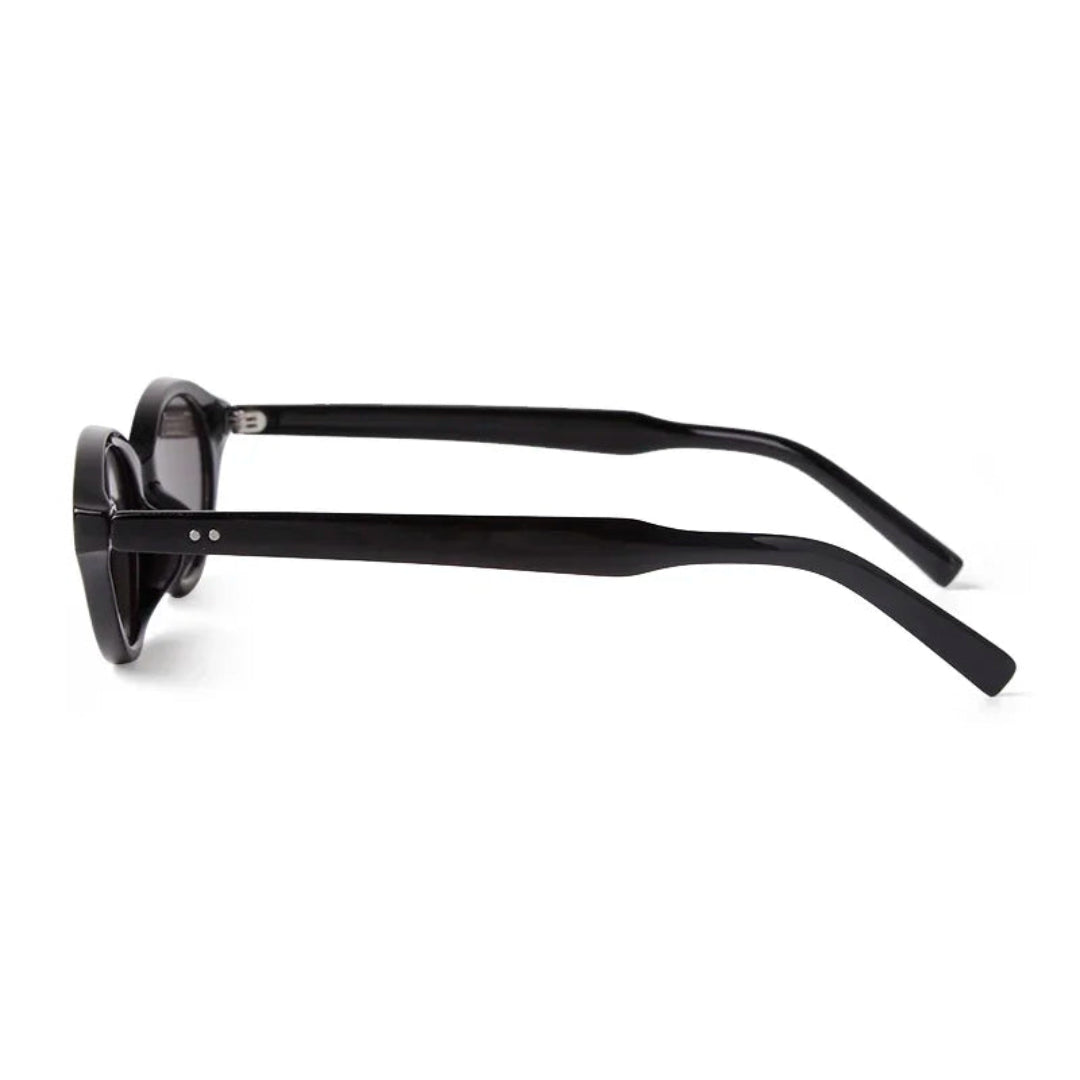 Side view of Sovereign women’s oval slim sunglasses in Black frame with Black lenses, on white background — polycarbonate frame, acrylic lenses, 100% UV protection