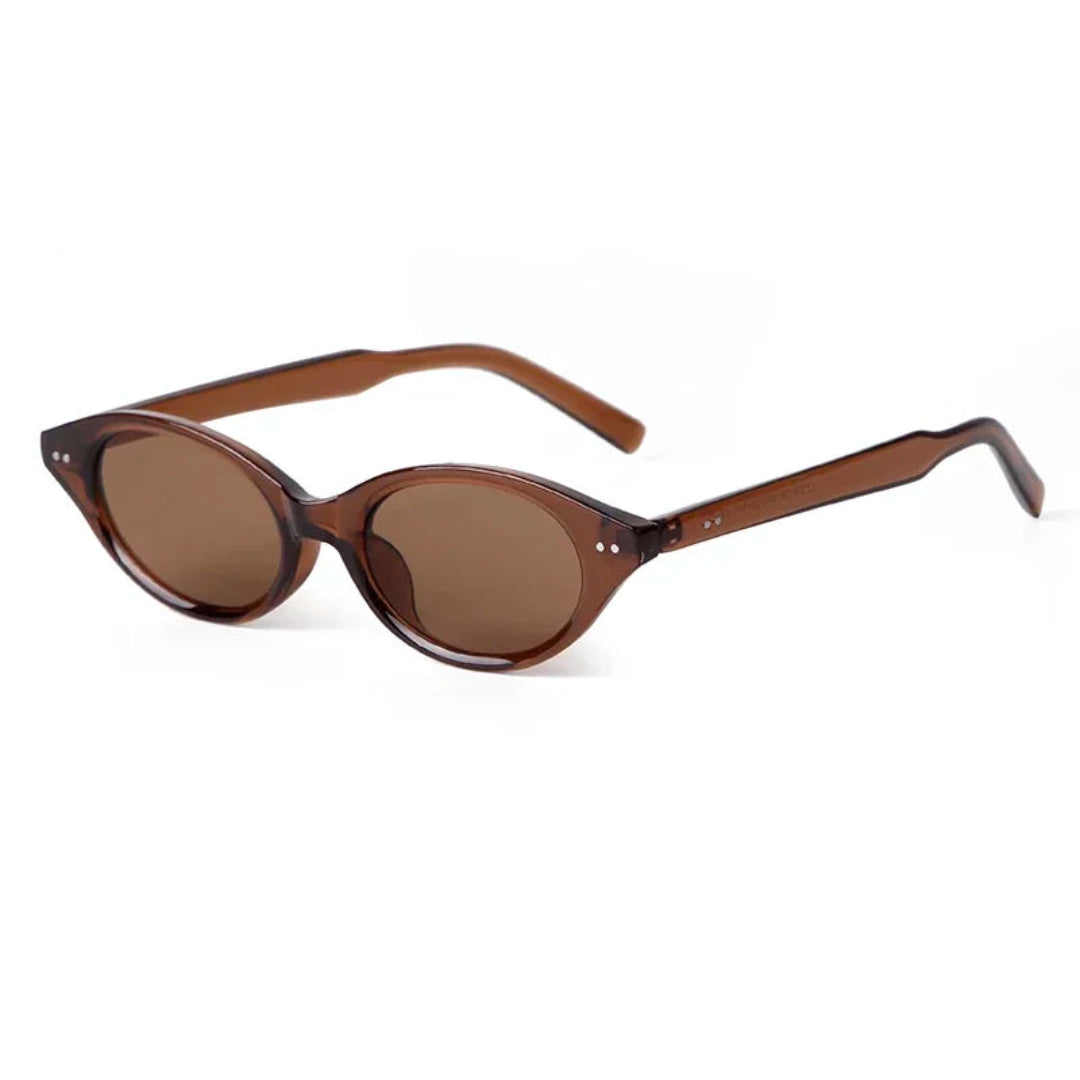 Sovereign women’s oval slim sunglasses in Brown frame with Amber lenses, right 3/4 angle on white background — polycarbonate frame, acrylic lenses, 100% UV protection