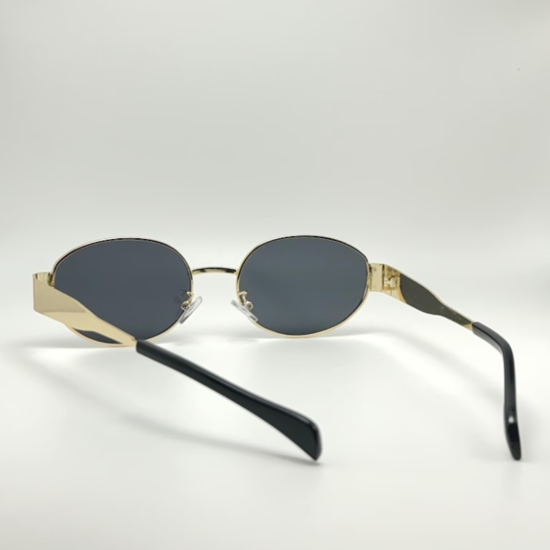 Rear view of Aurora women’s retro oval sunglasses in Gold frame with Black lenses, temples crossed, on white background — stainless steel frame, polycarbonate lenses, UV400 protection
