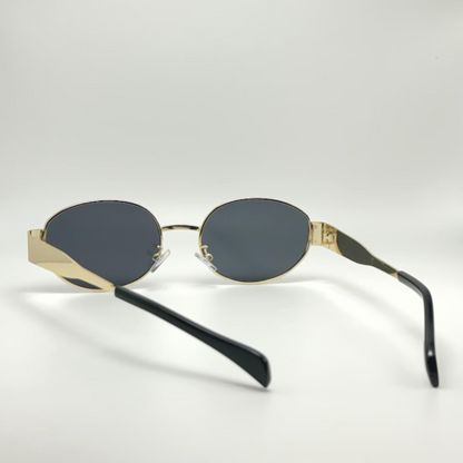 Rear view of Aurora women’s retro oval sunglasses in Gold frame with Black lenses, temples crossed, on white background — stainless steel frame, polycarbonate lenses, UV400 protection